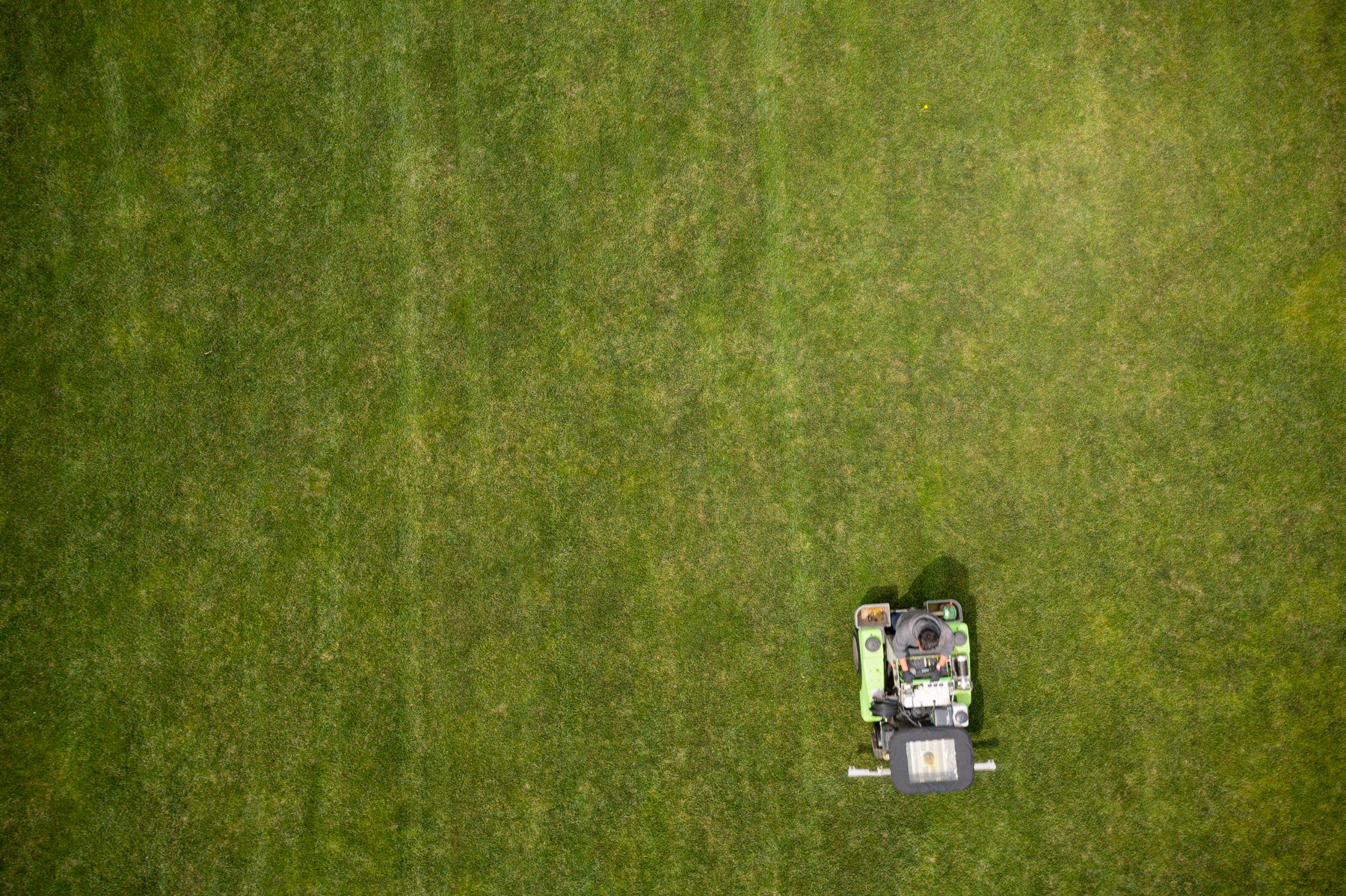 Lawn care technician applying fertilizer