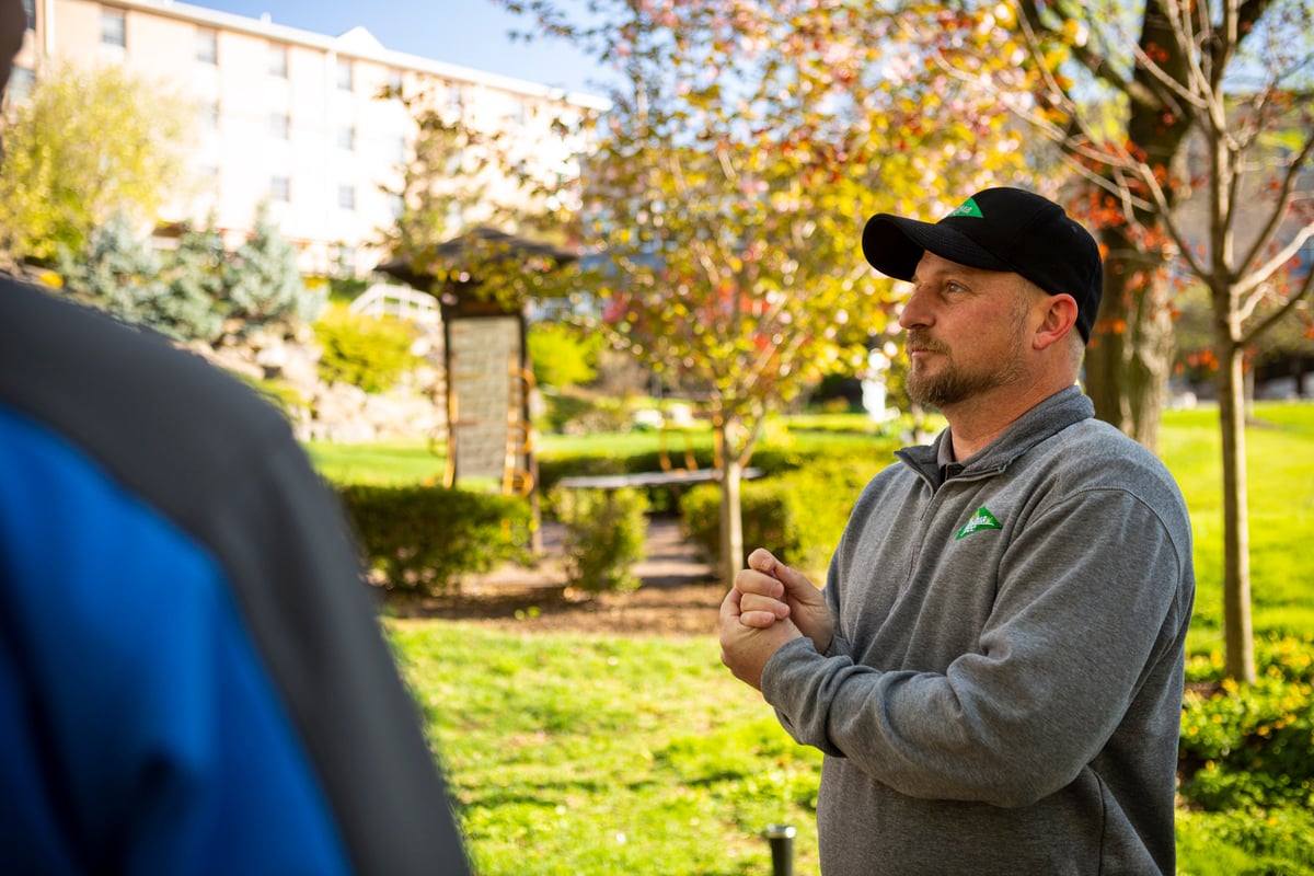 customer talks with lawn care expert