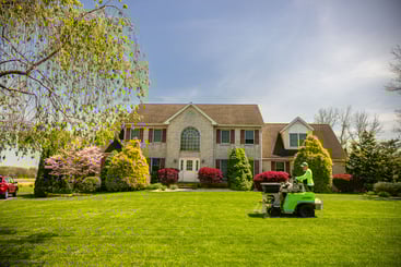 lawn care technician spreading product on a nice yard
