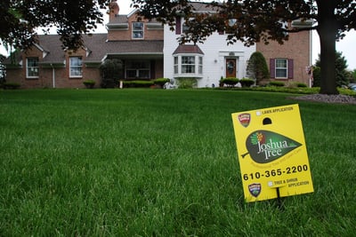 Joshua Tree lawn care sign on beautiful lawn