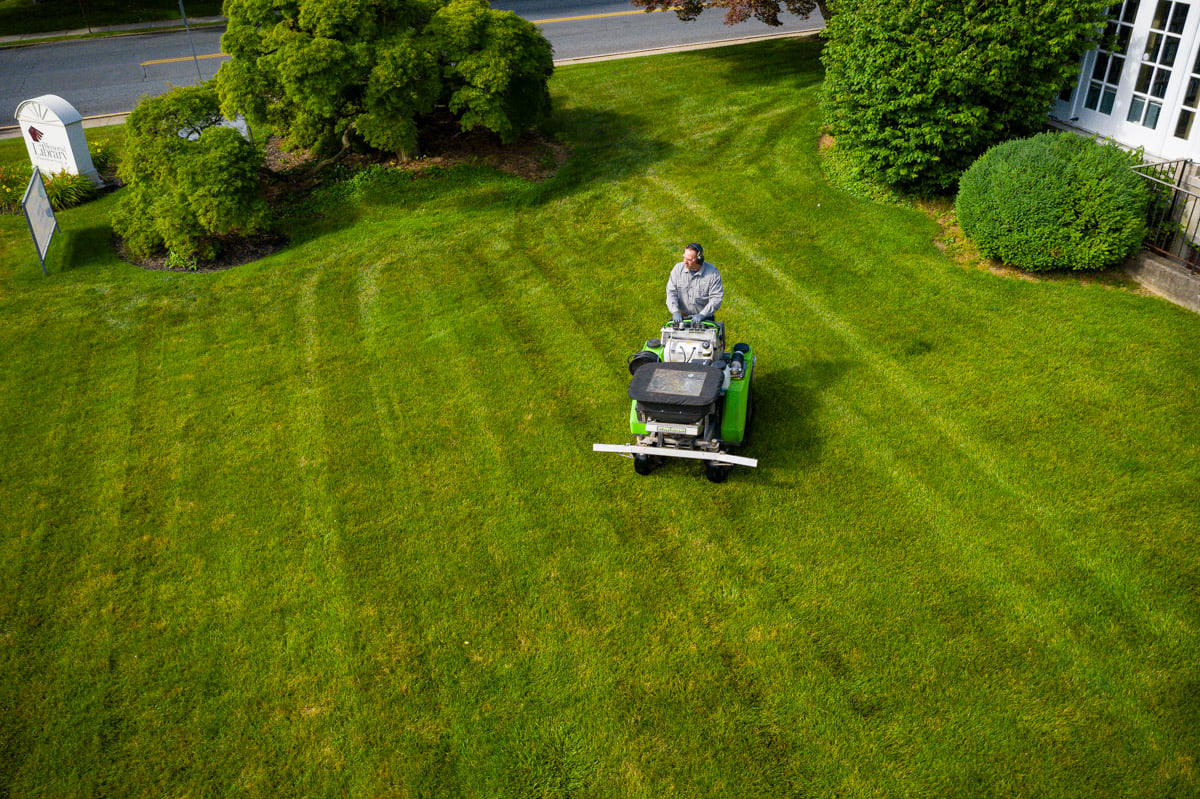 Lawn care technician spraying liquid fertilizer