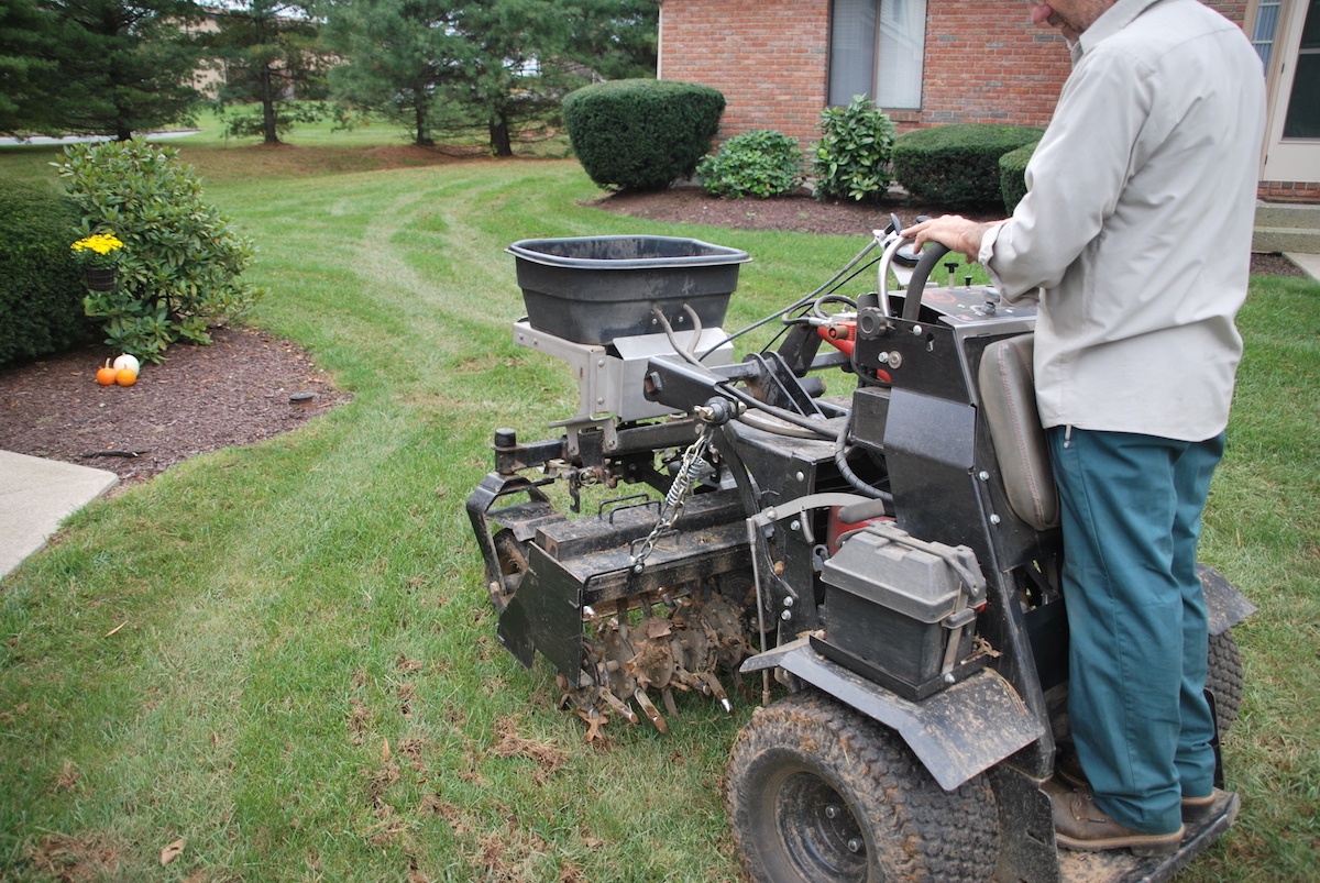 Lawn care technician aerating a lawn