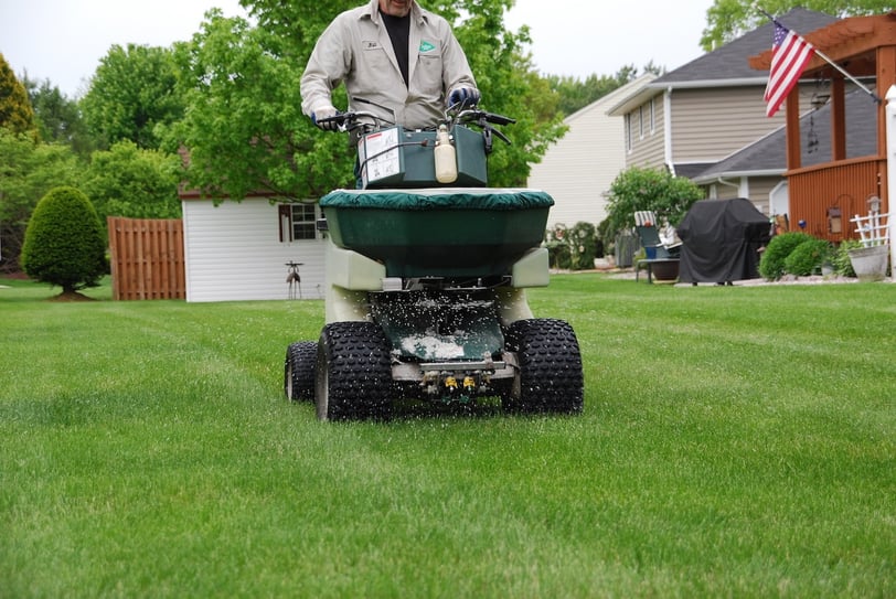 lawn technician applying fertilizer