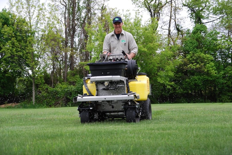 lawn care technician applying crabgrass control