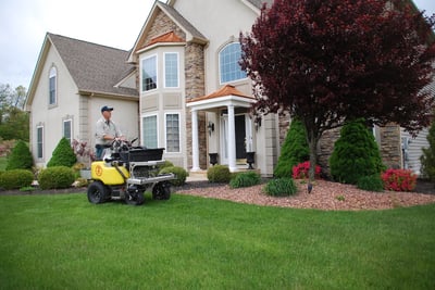 lawn care service technician treating lawn