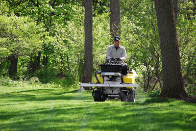 lawn care company applying weed control