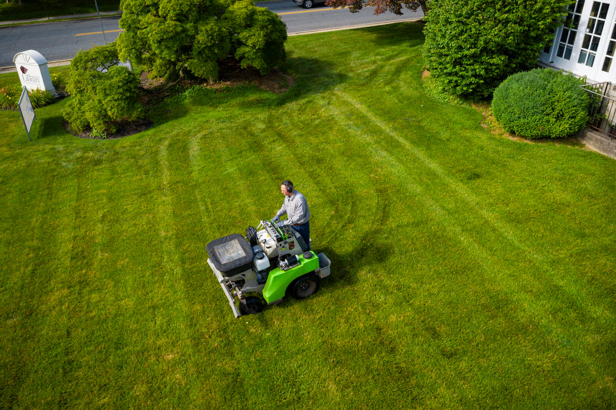 Lawn care technician applying fertilizer