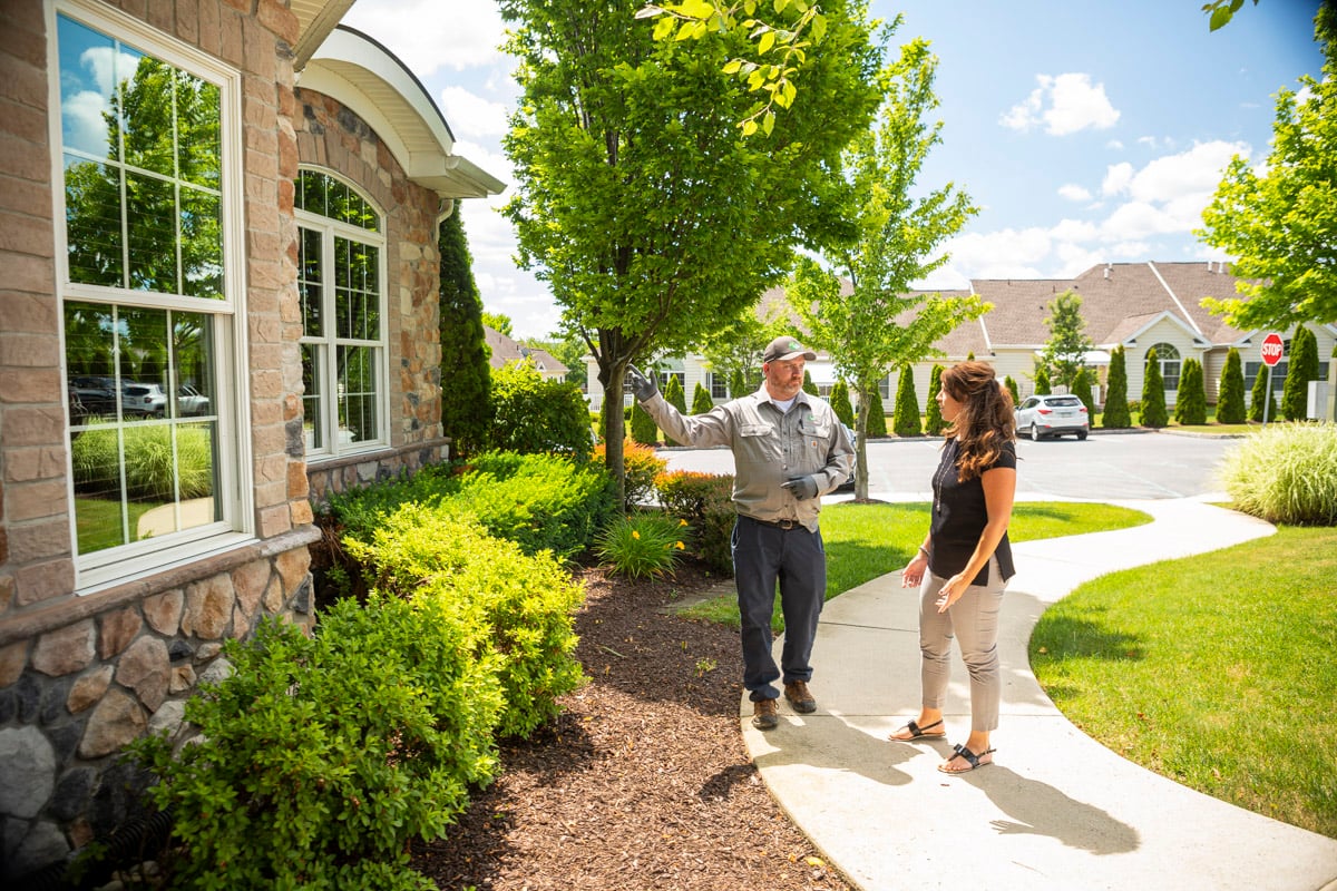 pest control expert inspects home with customer