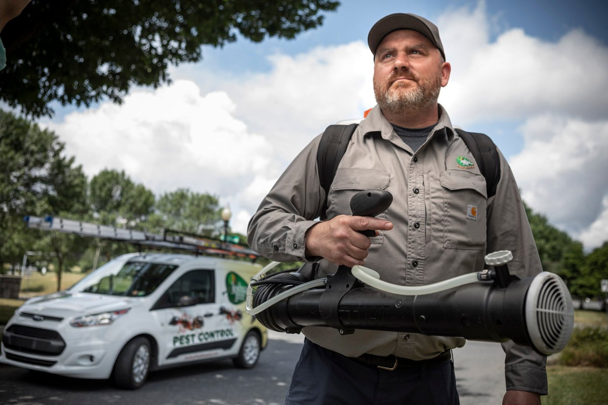 pest control expert prepares to spray for mosquitoes