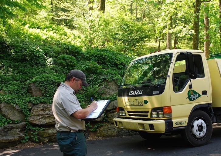 plant health care specialist inspecting a landscape for pests and plant disease