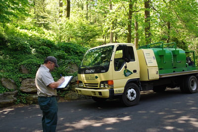 Joshua Tree technician reviewing paperwork near truck