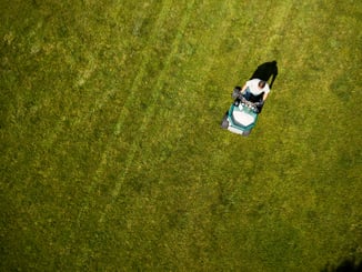 lawn care technician applying products to a backyard