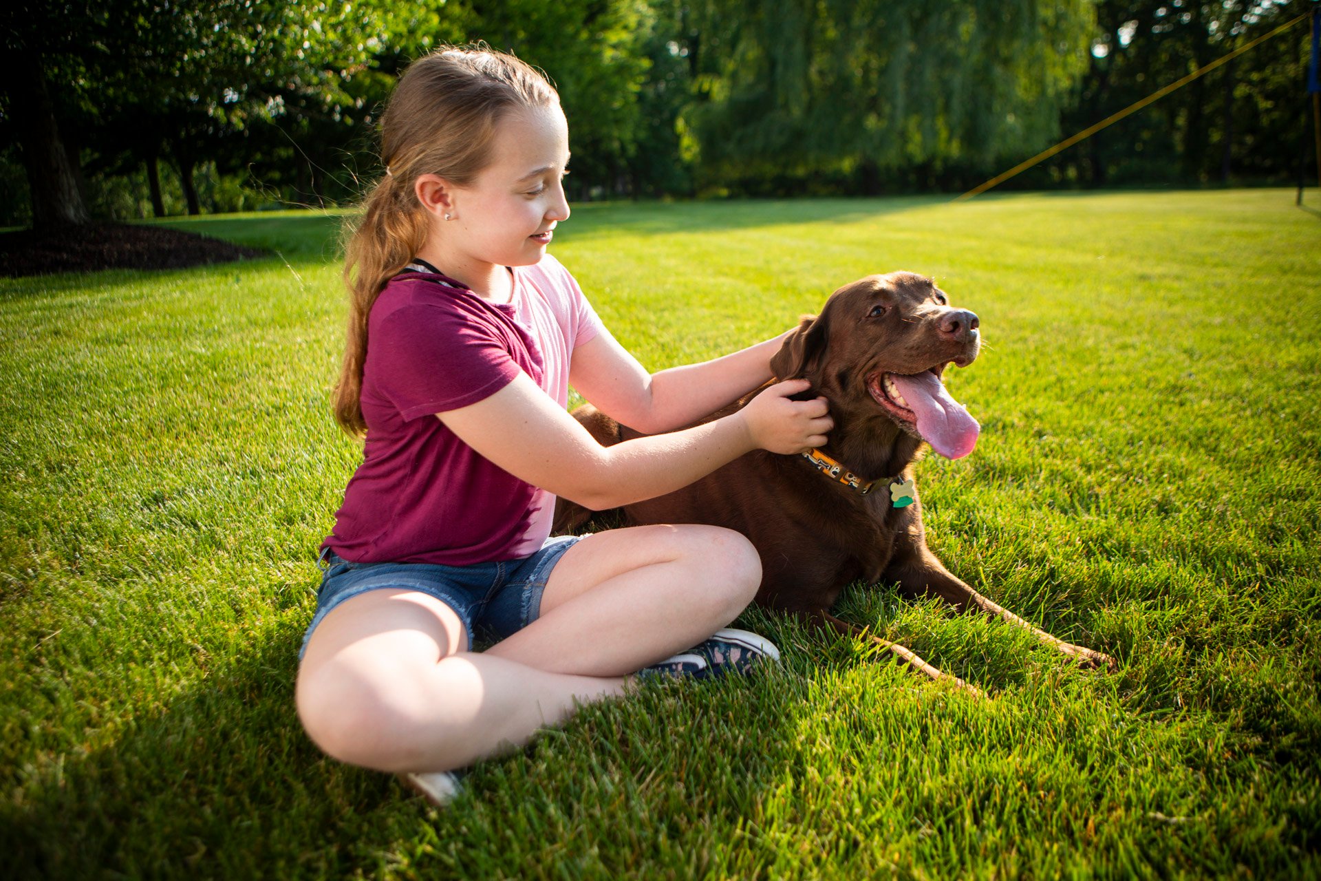 Child and dog in yard with tick control