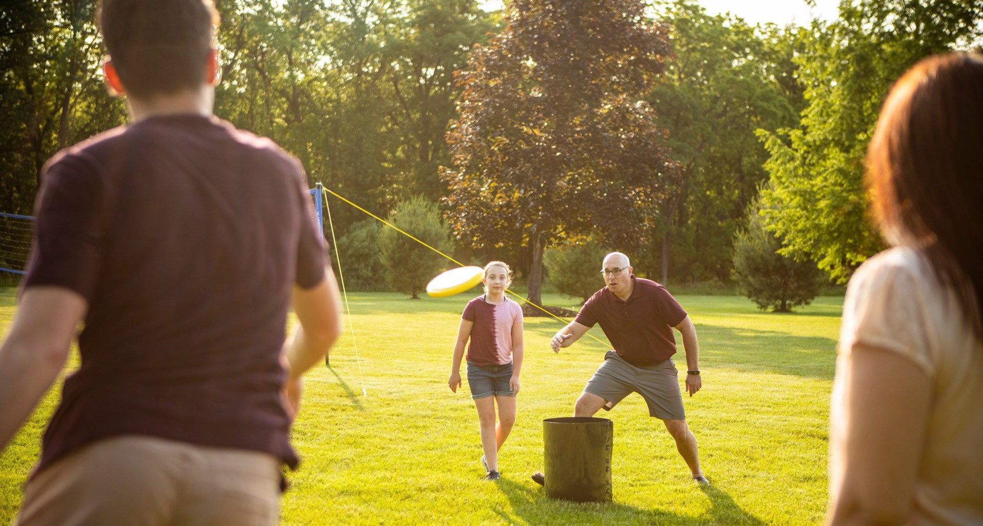 Family in lawn with healthy grass from lawn services